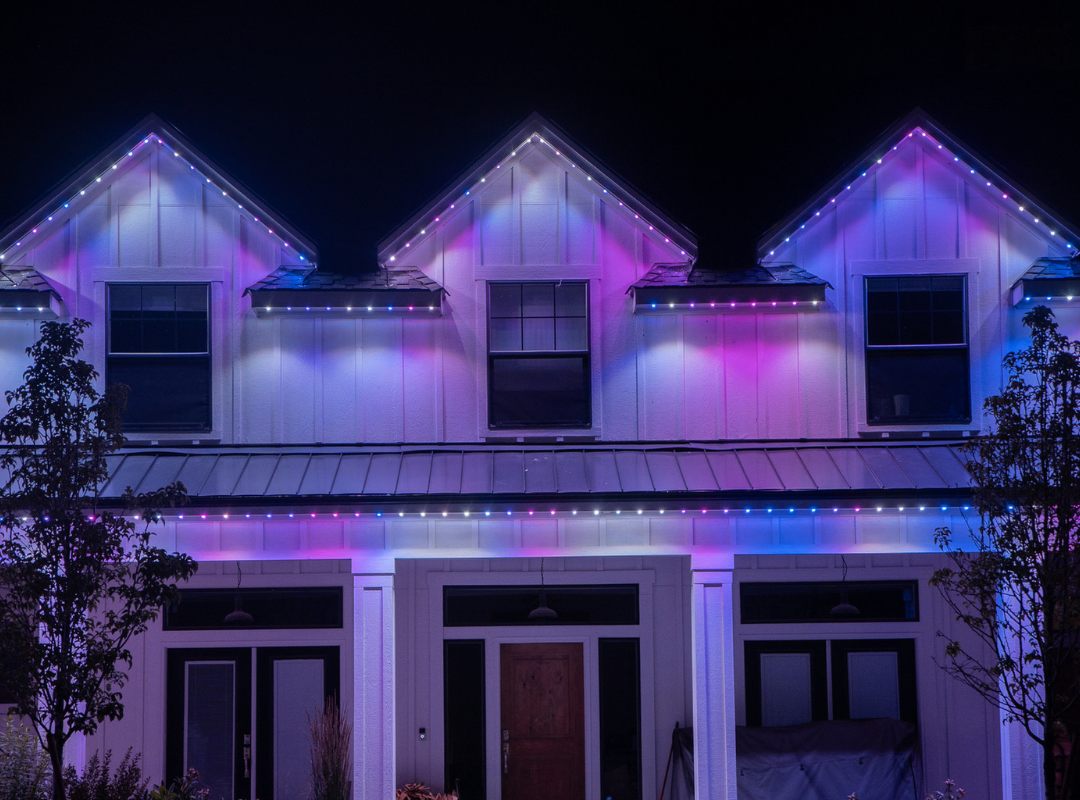 The same home lit in purple and blue for a game day
