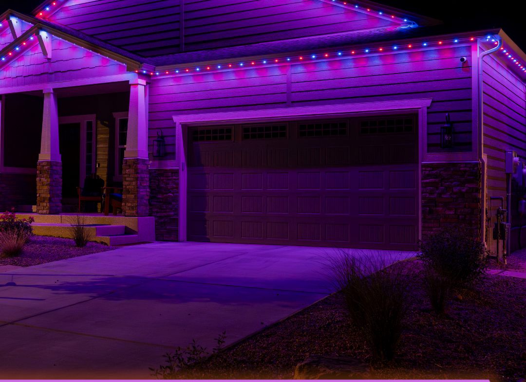 The same home lit in purple with red and blue accents